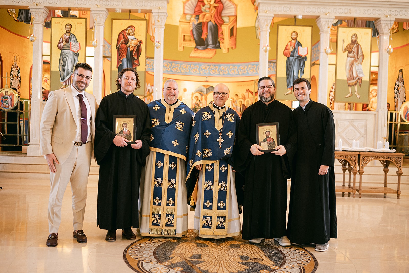 Clergy in vestments holding icons before the altar at the close of the Liturgy