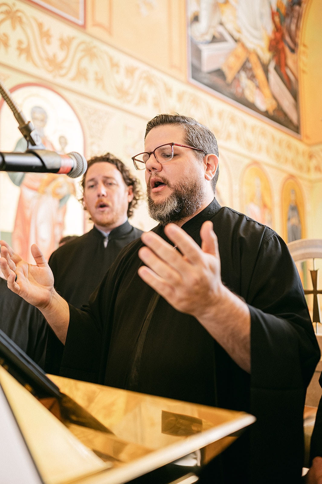 An instructor demonstrating a phrase at the analogion